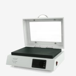 Close-up of the clear hinged humidity cover on the XH-2005 slide warmer for specimen protection.